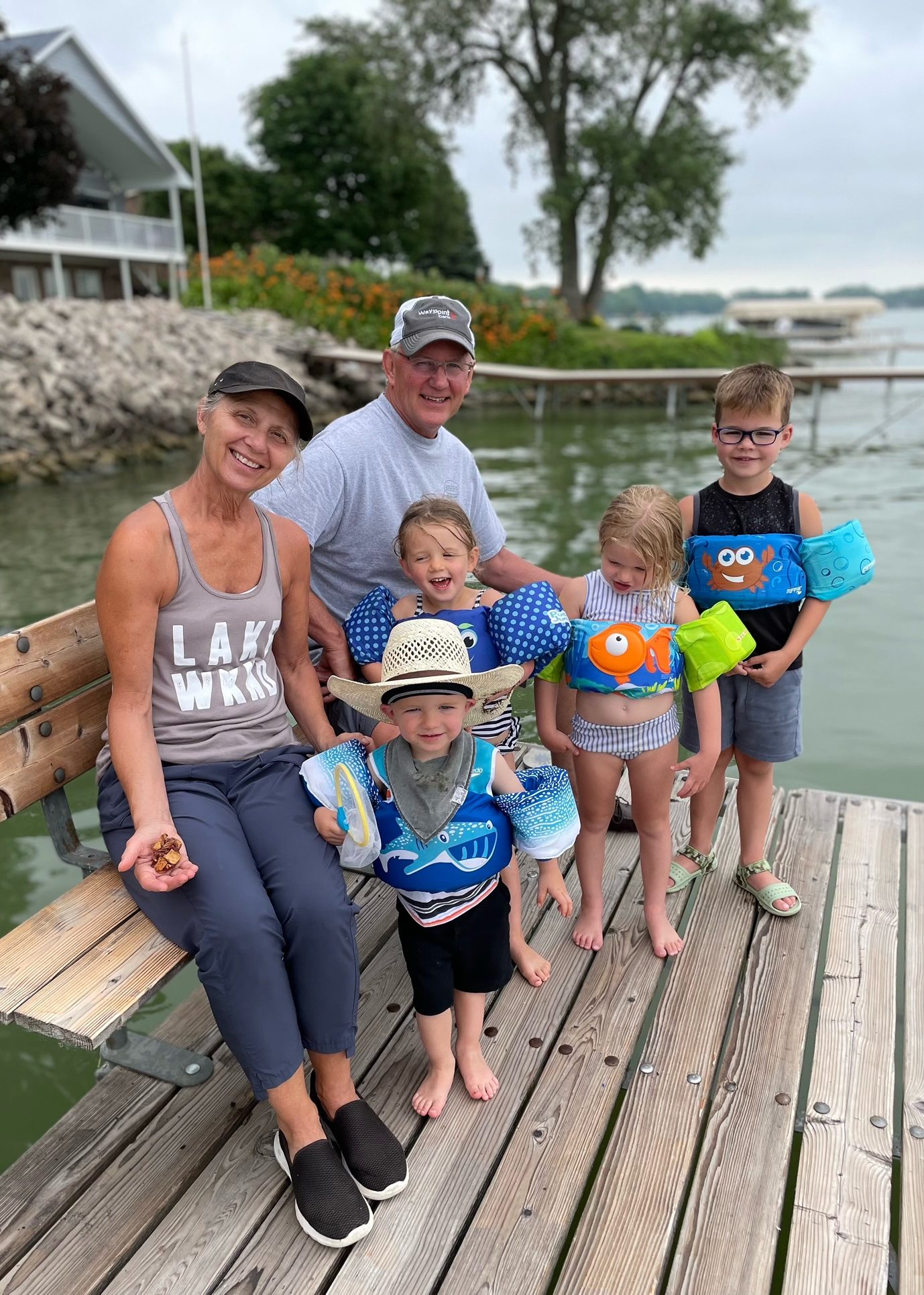 Kirk and wife with grandkids at a dock